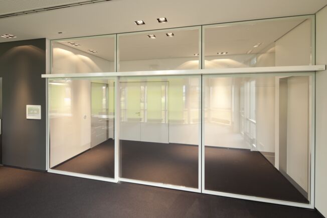 Entraînement automatique de porte coulissante Slimdrive SL NT avec système tout verre intégré (IGG) dans le bâtiment d entreprise de GEZE GmbH, Leonberg Système de porte coulissante linéaire automatique avec IGG, faible hauteur de construction et ligne de conception claire
