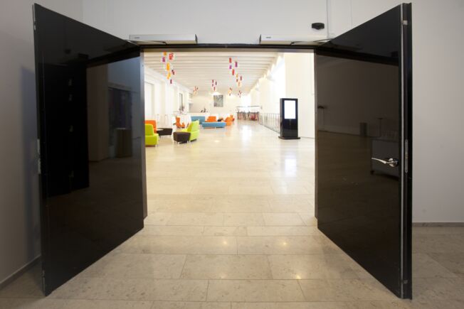 Swing door drive - Slimdrive EMD F-IS, Tivoli congress centre Copenhagen Electromechanical swing door system for double leaf fire and smoke protection doors with integrated mechanical closing sequence control