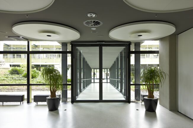 Club Coubertin in Munich equipped with Slimdrive EMD F-IS Electromechanical swing door system for double leaf fire and smoke protection doors with closing sequence control
