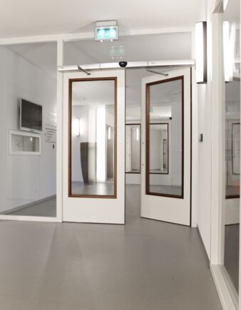 Swing door system - Slimdrive EMD-F IS, St. Elisabeth Electromechanical swing door system for double leaf fire and smoke protection doors with integrated mechanical closing sequence control