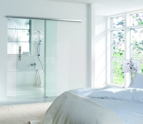 Levolan 60 sliding door system, installed in a residential building Sliding fitting for glass leaves weighing 60 kg and with one or damped on both sides for doors, so that the door is gently slowed down and independently dragged into the end position