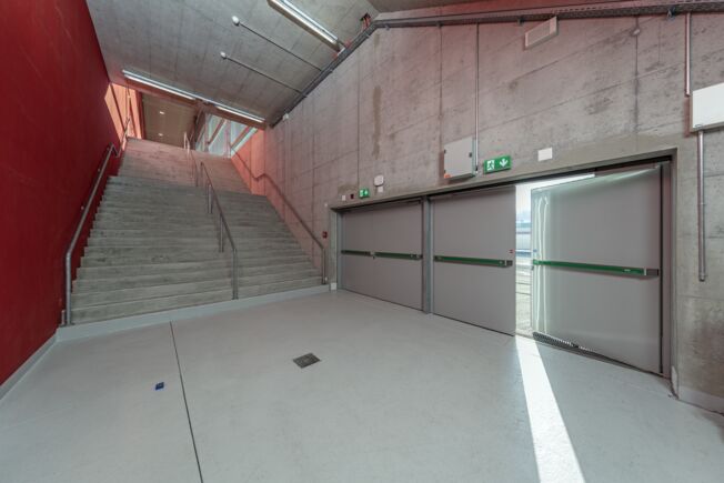 Emergency exit Tissot Arena Biel with RWA K 600 Staircase and emergency exit of the Tissot Arena Biel with retractable arm drive RWA K 600 on double leaf door with closing sequence control.