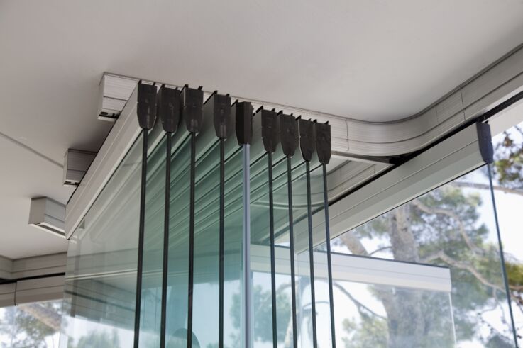 Sliding doors made of glass provide natural light in rooms.