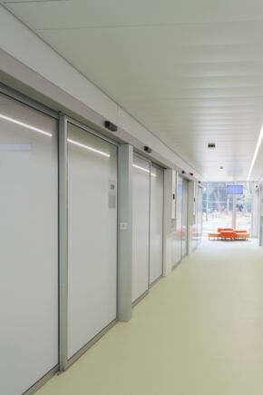Centrul de Oncologie Pediatric  SJD Zona în care se afl  s lile de opera ie, s lile de imagistic   i zona special  pentru pacien ii imunodeprima i este echipat  cu u i deosebit de igienice  i cu sistemul automat de u i glisante liniare Powerdrive PL-HT, special conceput pentru u i mari  i grele în zone cu cerin e sporite de igien .